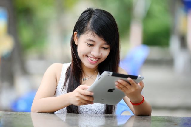 Woman Holding White Ipad